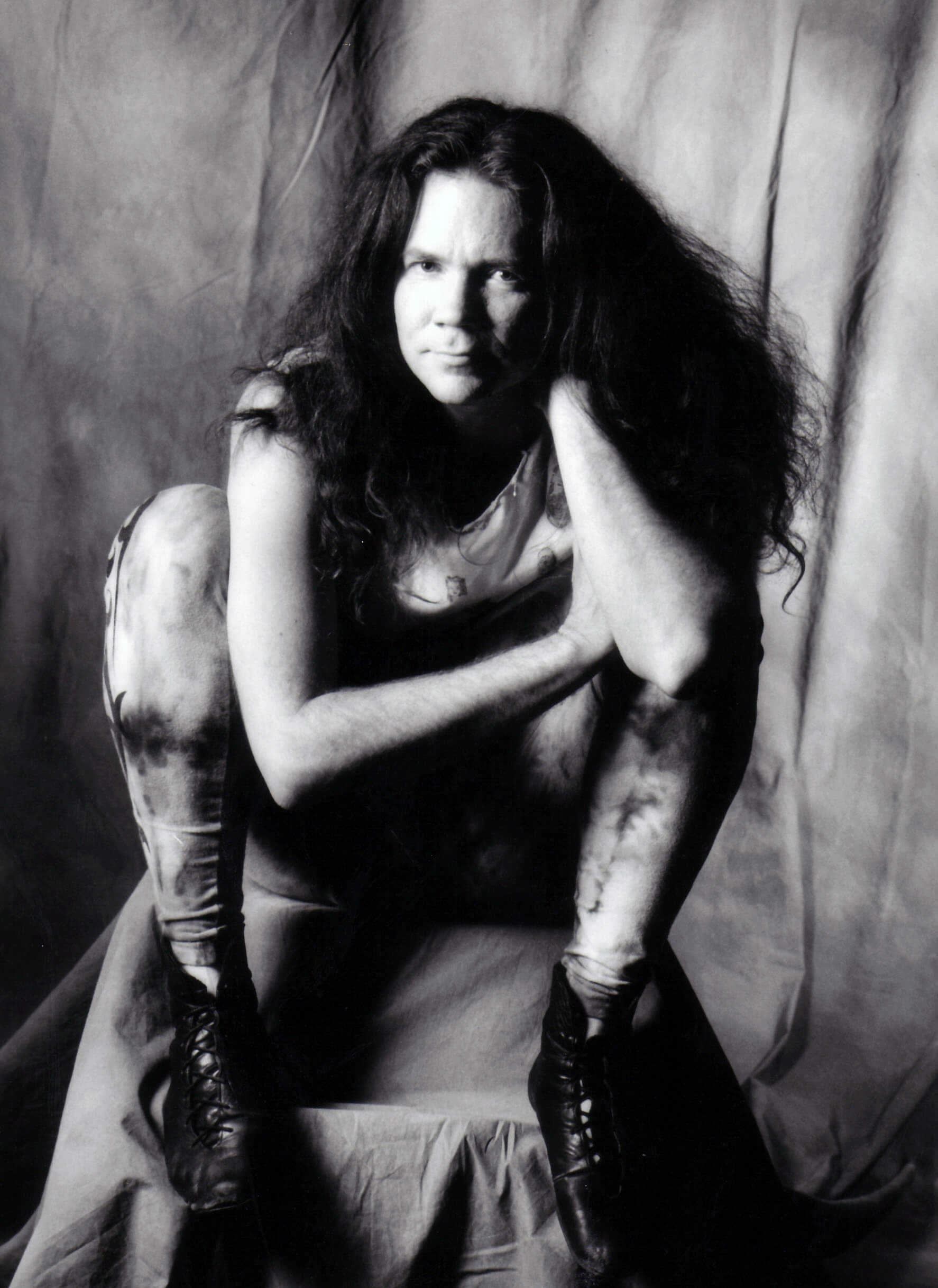 Michael in a photo studio, crouched and looking at the camera