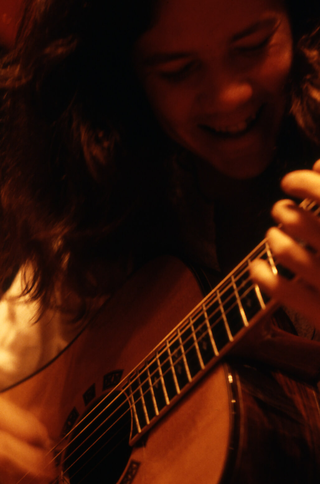 Smiling at the guitar