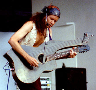 Michael on stage, playing a harp guitar