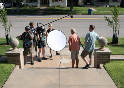 Film crew interviews Carol and Craig Hedges outside of Michael's family home. Photo credit: Brian Malone.
