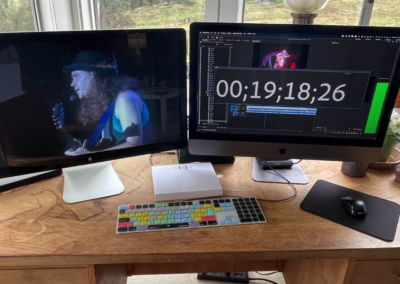 Two computer monitors, with timecode and video footage of Michael Hedges displayed