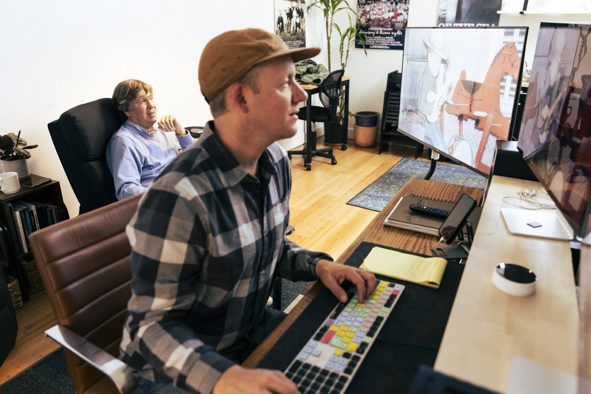 Two film directors, reviewing footage on a flatscreen television
