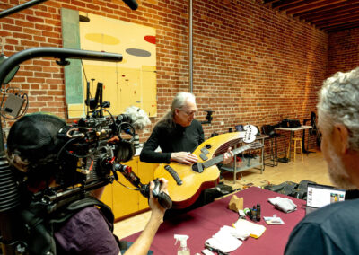 Hilleary Burgess holds Michael's Dyer Harp Guitar and tells a story. Photo Credit: Monica Semergiu