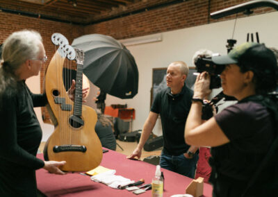 Hilleary Burgess holds Michael's Dyer Harp Guitar and tells a story. Photo Credit: Monica Semergiu