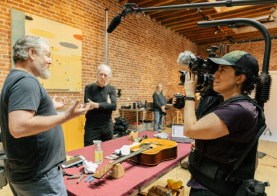 Director of Photography Clare Major films biographer Jake White telling a story about "Barbara", Michael's Martin D-28. Photo Credit: Monica Semergiu