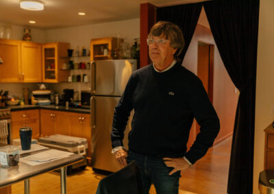 Oracle Writer & Co-Director Brendan Hedges looks on as Michael's guitars are photographed. Photo Credit: Monica Semergiu