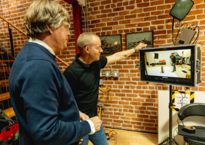 Oracle Co-Directors Brendan Hedges and Mischa Hedges review monitor as the photo shoot is captured for a scene in Oracle. Photo Credit: Monica Semergiu