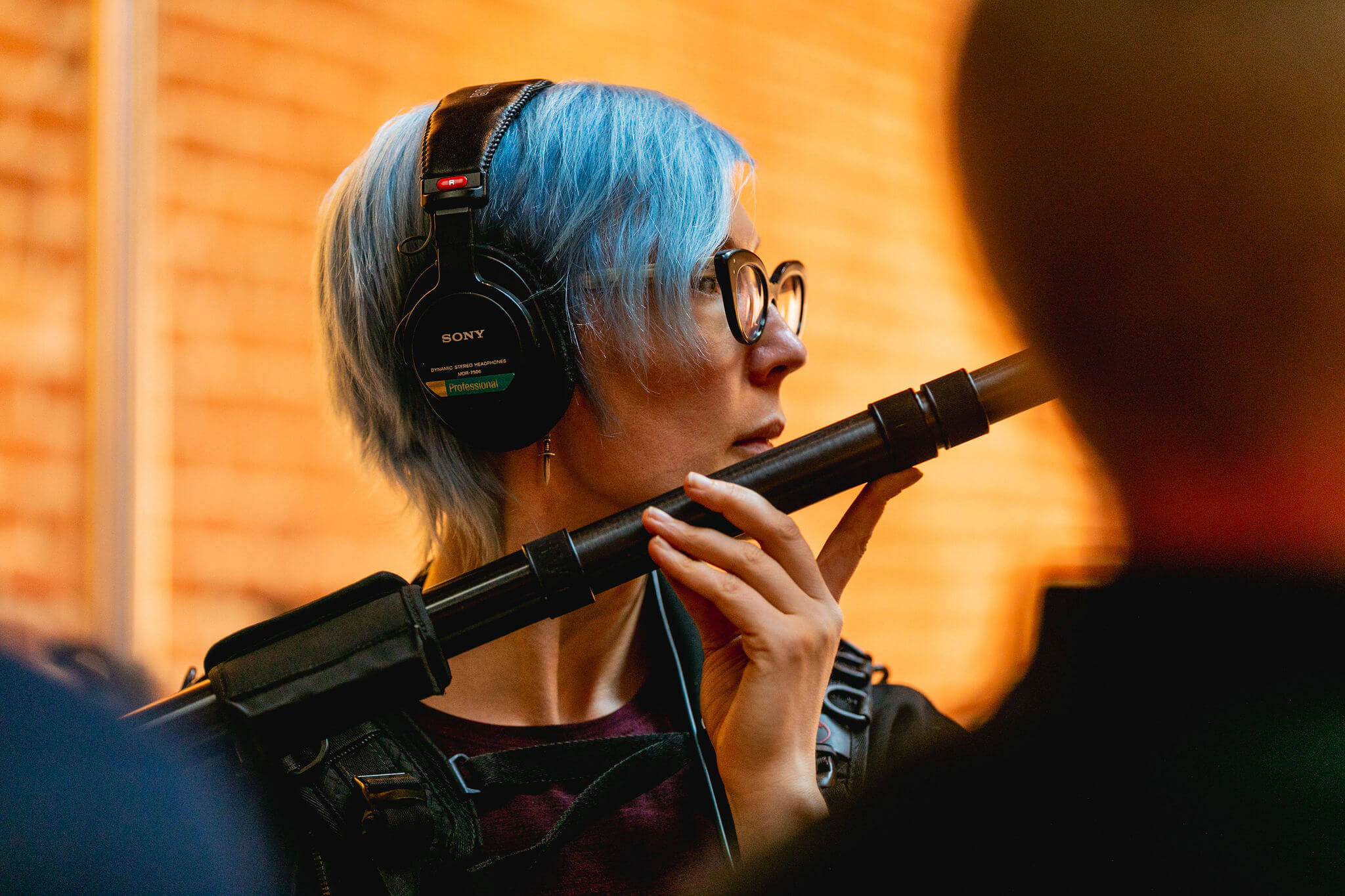 Location Sound Recordist Paige Goedkoop holds the boom mic during an interview. Photo Credit: Monica Semergiu