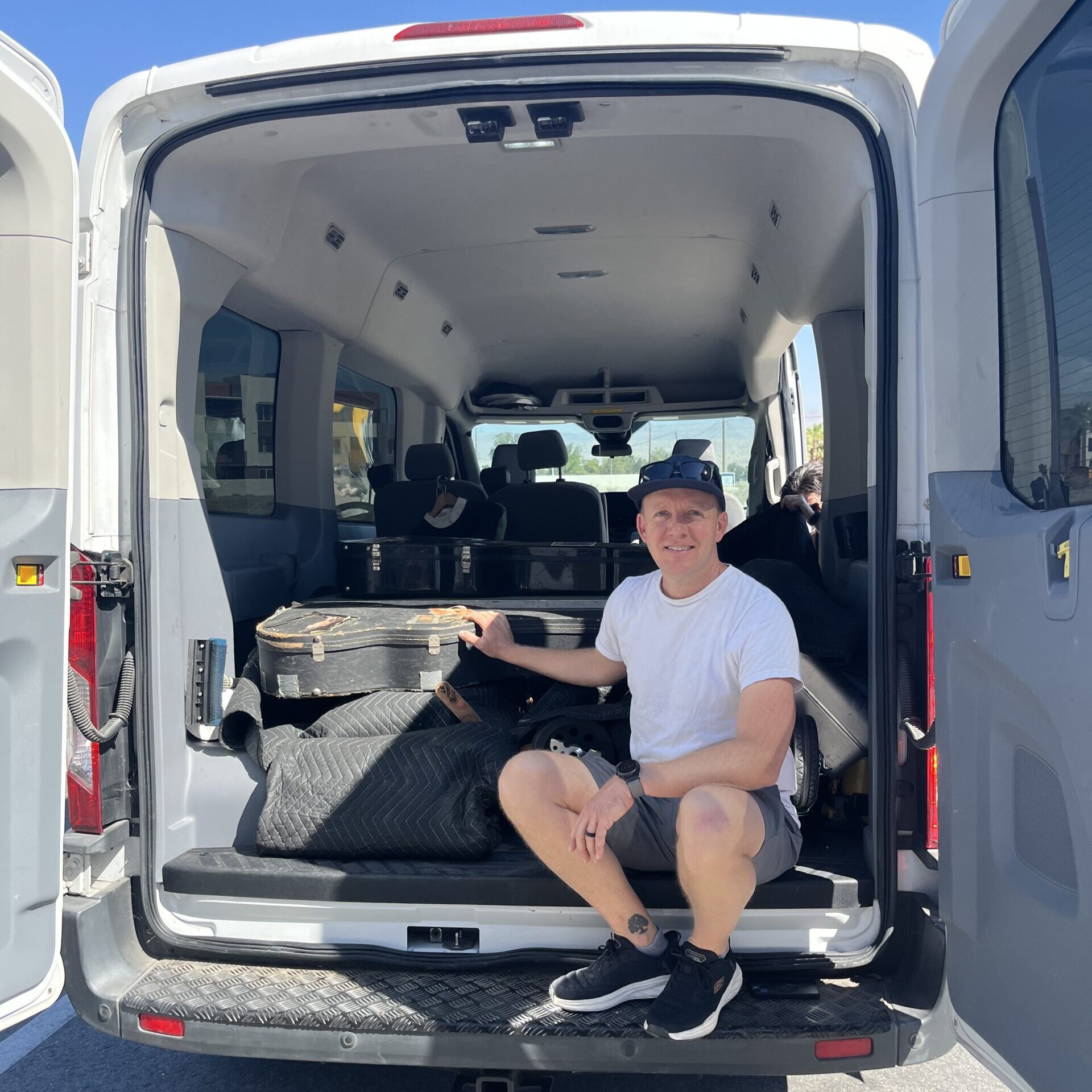 Mischa Hedges with Michael's guitars in the van. Photo Credit: Brendan Hedges